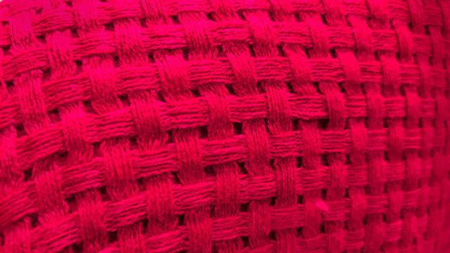 Coarse red woven fabric weave textile macro background
