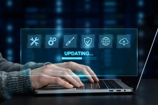 Person typing on a laptop with a glowing blue digital overlay showing a software update progress bar and various technical maintenance