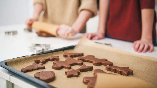 Sisters Baking Gingerbread Cookies For A Christmas Celebration