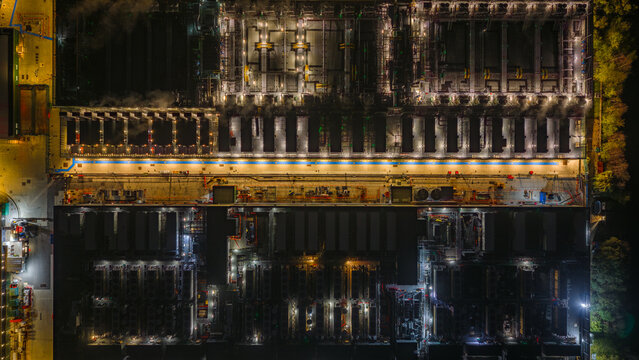 Aerial view of the NTT LON1B Data Centre at night, featuring illuminated industrial infrastructure, cooling units, and a geometric layout in Dagenham, England, United Kingdom.