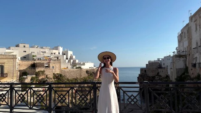 Woman Walking from a Seaside Viewpoint in Polignano a Mare, Italy