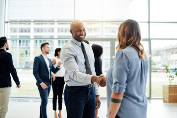 Business, handshake and people in office, hello and welcome with introduction. Cooperation, agreement and employees in workplace, shaking hands and smile with partnership, thank you and greeting © peopleimages.com
