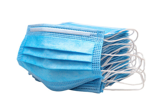 Stack of light blue disposable face masks with ear loops isolated on transparent background. Essential protection stack of blue medical face masks isolated on white background.