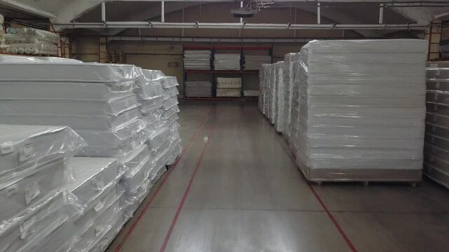 Forward drone flight between mattress rows in Klin