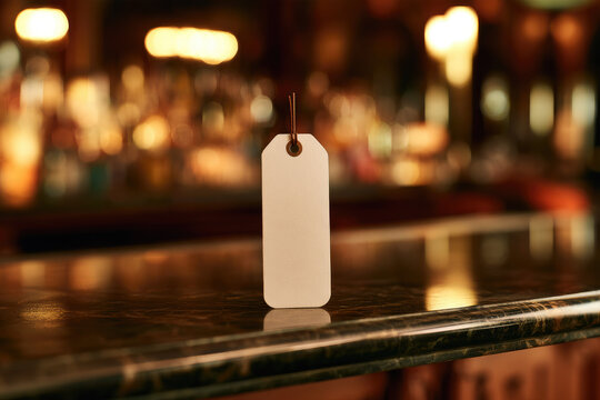 White coat check ticket on dark marble reception ledge with warm bar lighting, shallow focus, clean negative space, and elegant nightlife hospitality mood for service design