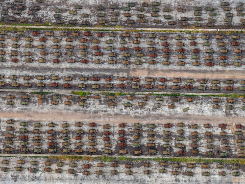 Aerial view of rows of sugar cane transport carts parked in an organized grid pattern at the Sahyadri Co-operative Sugar Factory in Yeshwantnagar, Maharashtra, India.