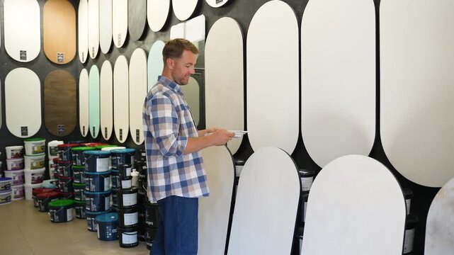 Designer choosing paint color in hardware store