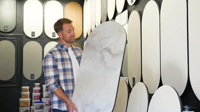 Designer choosing wall paint texture sample
