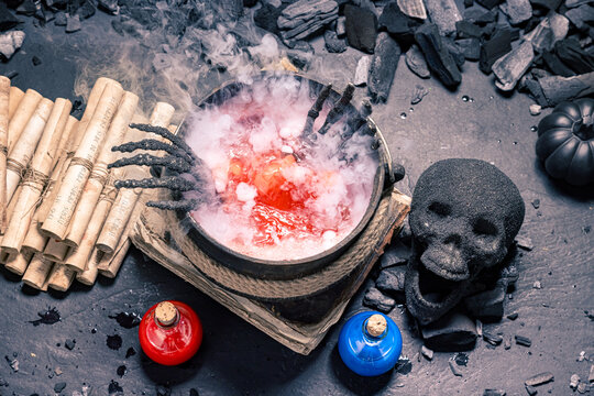 A dark skull rests beside glass flasks.