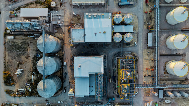 Aerial view of the construction of a distillery featuring large metal storage silos, industrial buildings, and steel frameworks in Kovacica, Vojvodina, Serbia.