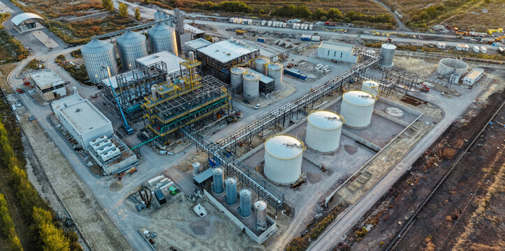 Aerial view of the construction of a distillery featuring large metal silos, storage tanks, and structural steel frameworks in an industrial site in Kovacica, Vojvodina, Serbia.