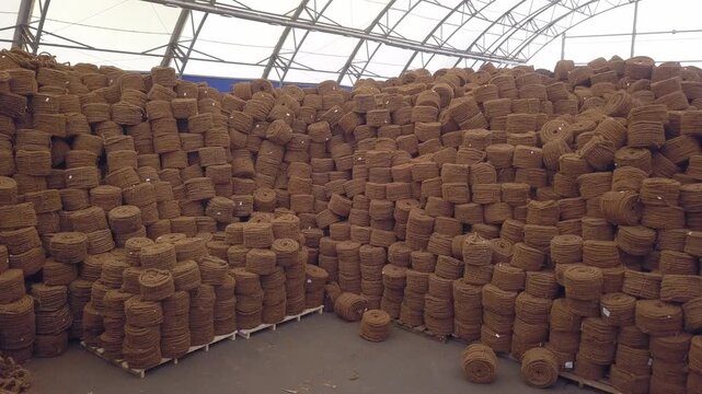 Close turn toward a rope pile in a Klin hangar