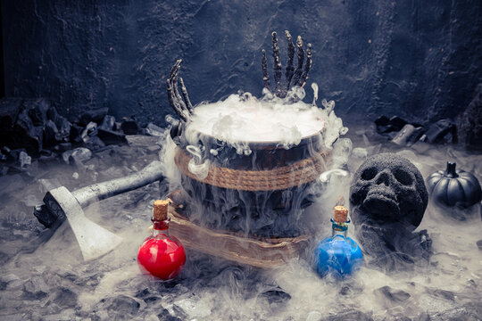 Skeletal hands rise above dense white vapor.