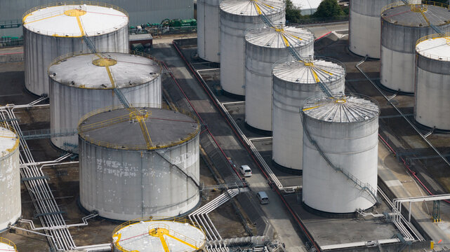 Aerial view of Navigator Terminals Thames featuring large industrial storage tanks, complex piping networks, and service roads in Grays, England, United Kingdom.