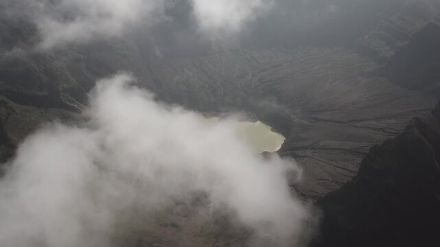 Dramatic Aerial View of a Volcanic Crater Lake Shrouded in Clouds at Kelud Mountain, Kediri, East Java
