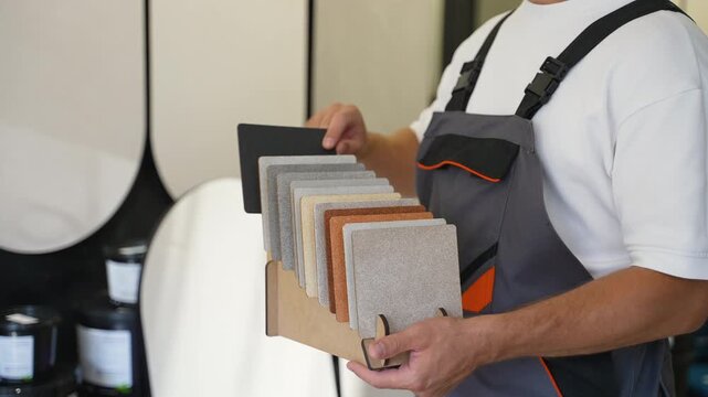 Construction worker showing facade material color samples