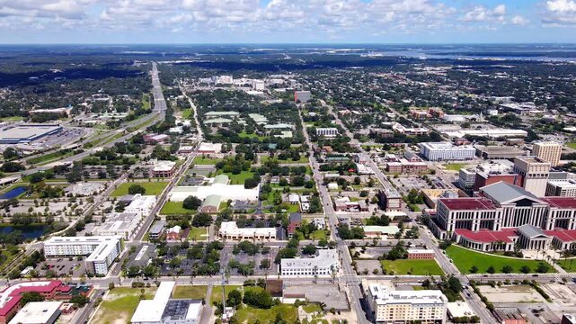 Jacksonville neighborhoods and street corridors extend beneath a broad aerial view with clouds.
