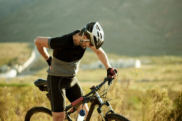 Back pain, cycling and man with training, joint injury and inflammation with hobby. Nature, person and cyclist with bike, muscle tension and space with practice, sore and workout with fitness © peopleimages.com