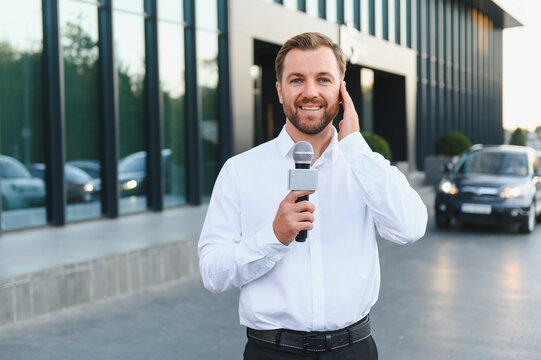 Male tv reporter broadcasting live with microphone