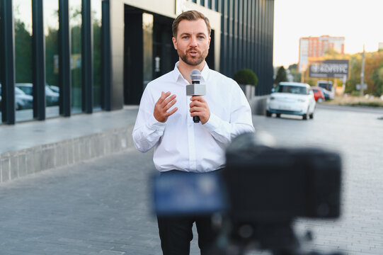 Male reporter broadcasting live news during reportage