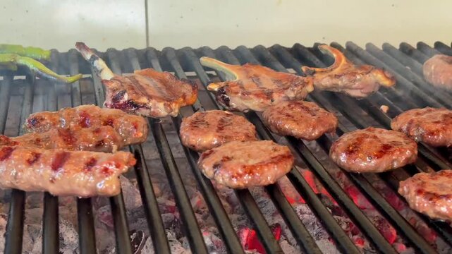 Grilling Meatballs and Lamb Chops Over a Traditional Wood Fire Barbecue
