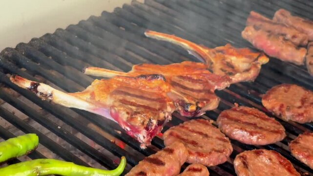 Grilling Meatballs and Lamb Chops Over a Traditional Wood Fire Barbecue