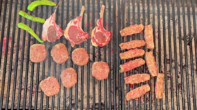 Grilling Meatballs and Lamb Chops Over a Traditional Wood Fire Barbecue