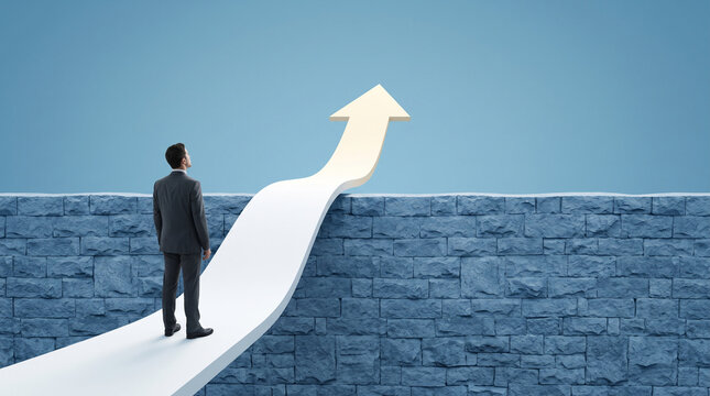 Man in suit looks up at upward arrow over brick wall, symbolizing overcoming obstacle and achieving success. free space, text, mockup, blank