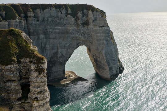Etretat sea arch and towering chalk cliffs above the sea
