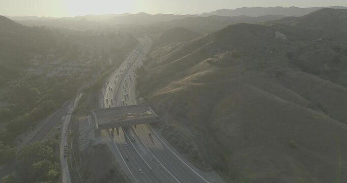 Aerial view of freeway with overpass bridge in hazy hills