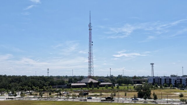 Aerial view of the Central Park at RiversEdge featuring a prominent communication tower surrounded by green spaces and modern urban development in Jacksonville, Florida, United States.