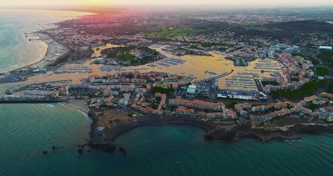 Aerial view of picturesque Mediterranean marina in the town of Agde, featuring sailing yachts. A popular seaside resort in the south of France, known for its sandy beaches, yachting