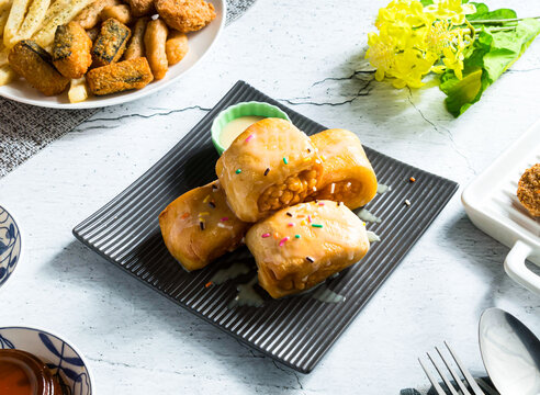 Deep fried silver thread rolls with condensed milk and sprinkles