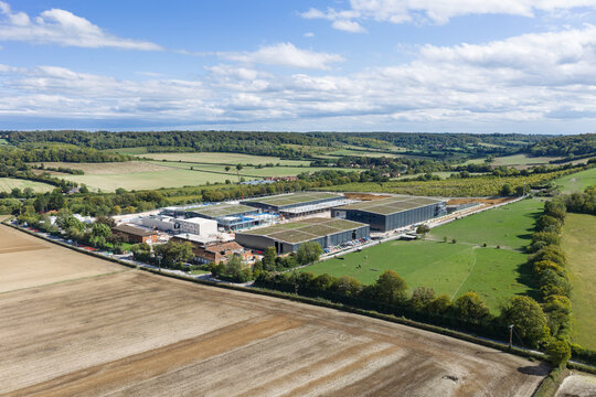 Aerial view of a large data center complex situated in the rural landscape of the United Kingdom.
