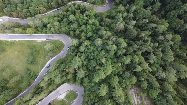Aerial Top View of Winding Hairpin Road Through Conifer Forest on Vrsic Pass (Vr&scaron;ič Pass), Slovenia. Russian Road in Slovenian Alps. Suitable for travel, car themed ads, road triggers, wallpapering.