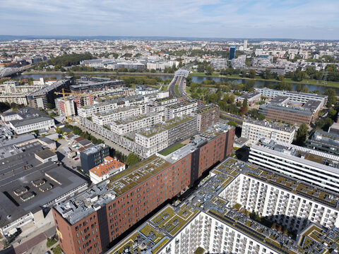 Aerial view of a modern residential development with green roofs and multi-story apartment buildings in the urban landscape of Krakow, Lesser Poland Voivode, Poland.