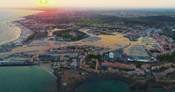 Aerial view of picturesque Mediterranean marina in the town of Agde, featuring sailing yachts. A popular seaside resort in the south of France, known for its sandy beaches, yachting