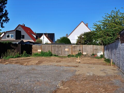 Prepared ground and gravel foundation for residential building project in suburban area