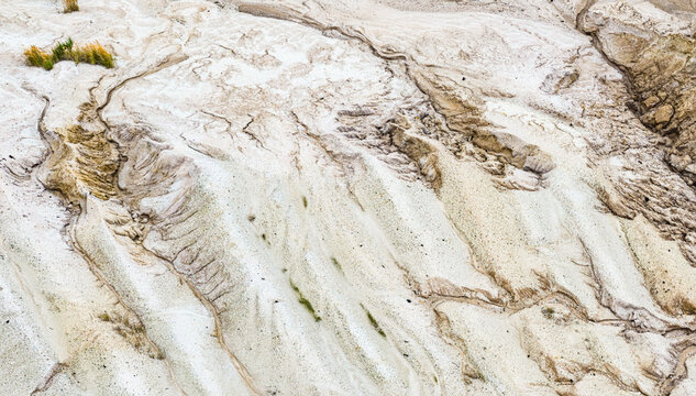 Aerial view of the eroded sandy landscape and textured terrain of the Tagebau Hambach open-pit mine in Elsdorf, Nordrhein-Westfalen, Germany.