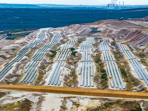 Aerial view of solar panels installed in the Tagebau Hambach open-pit mine with industrial landscape in Elsdorf, Nordrhein-Westfalen, Germany.