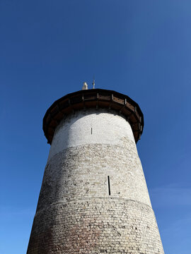 Round stone tower against a clear blue sky
