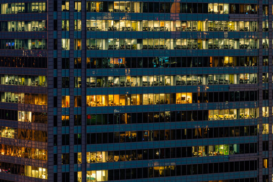 Aerial view of the illuminated windows of a modern skyscraper in the financial center of Warsaw, Masovian Voivodeship, Poland.