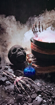 A witch cauldron sits on an ancient spellbook.