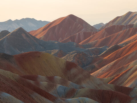 View of the colorful sandstone mountains of the Zhangye Danxia National Geopark with layered rock formations and dramatic light in Zhangye, Gansu, China.