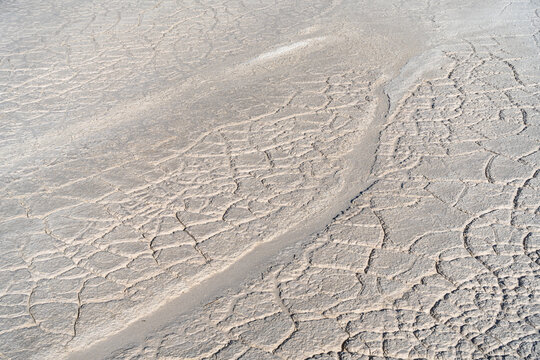 View of the dry, cracked surface of a tailings storage facility with intricate patterns in the parched earth in Padina, Varna, Bulgaria.