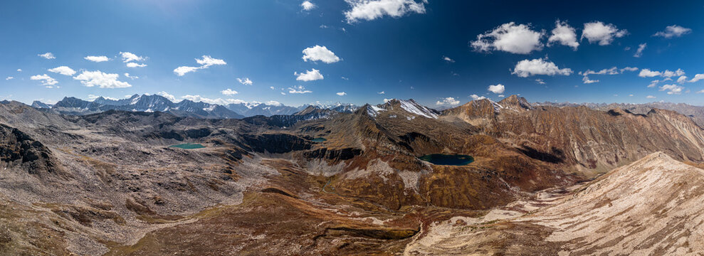 Aerial view of Maheen Lake nestled among the rugged, rocky peaks and slopes of the Himalayas in the mountainous terrain of Batakundi, Khyber Pakhtunkhwa, Pakistan.