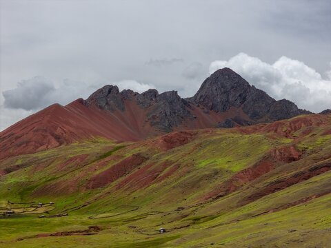 Aerial view of the Red Valley Peruvian Andes Rainbow Mountain trek Palccoyo canyon Vinicunca Cuszo Peru Peru siete colores Glaciar del Nevado Inca morning blue sky sunny clouds.