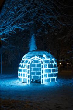View of an illuminated igloo-shaped light installation glowing in a snowy park at night in Sremska Mitrovica, Vojvodina, Serbia.