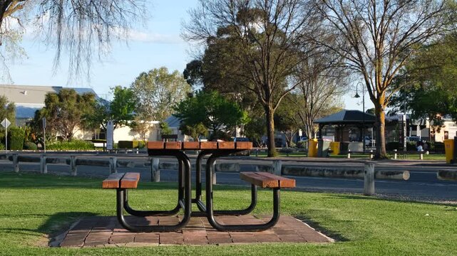 A picnic table on a green lawn at a roadside park in Keith, South Australia, Australia. Roadside rest and travel pause, public space for community gathering, road trip stopover infrastructure