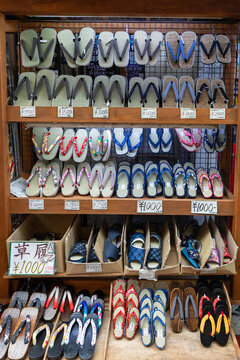 TOKYO, JAPAN &ndash; OCTOBER 2023: Rows of traditional Japanese zori and geta sandals displayed for sale at a local market stall with prices in Asakusa.